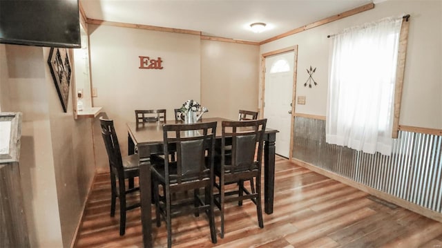 dining area with wood finished floors