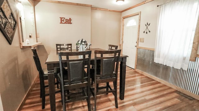 dining area featuring wood finished floors, baseboards, and visible vents