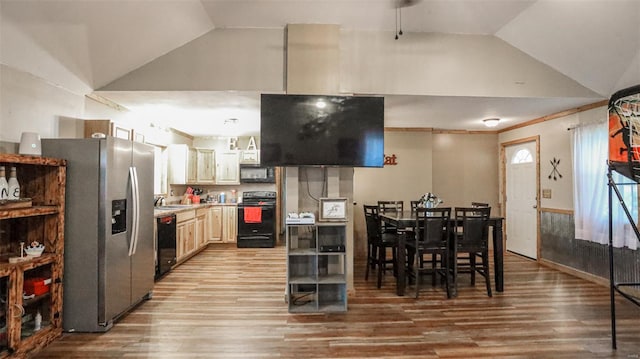 dining room with light wood finished floors and lofted ceiling