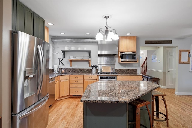 kitchen with open shelves, appliances with stainless steel finishes, a kitchen breakfast bar, and light wood finished floors
