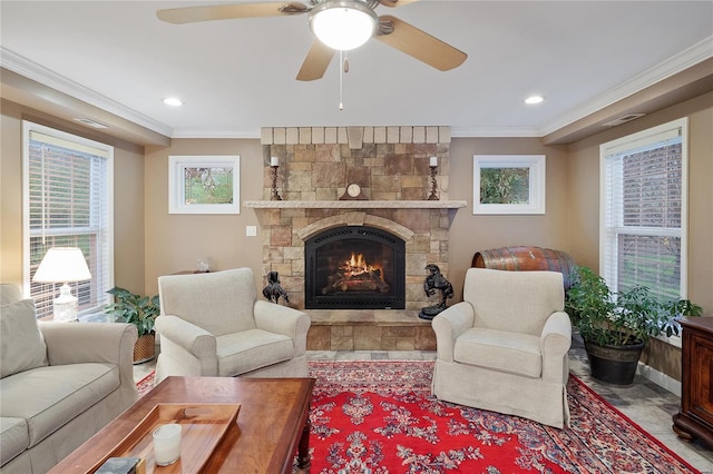 living area with plenty of natural light, a fireplace, visible vents, and ornamental molding