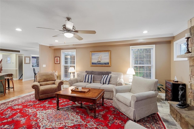 living area featuring baseboards, a ceiling fan, crown molding, recessed lighting, and light wood-style flooring