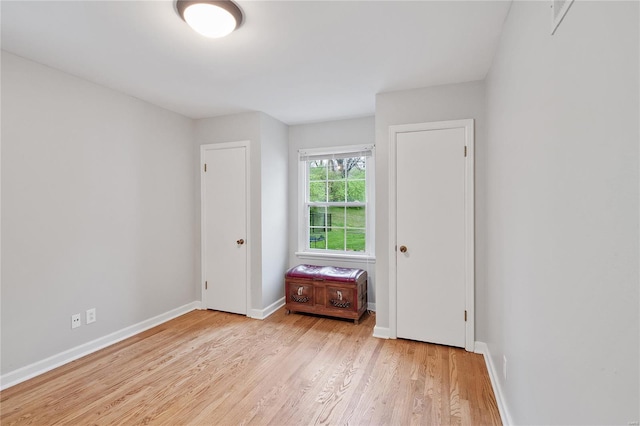 empty room featuring wood finished floors and baseboards
