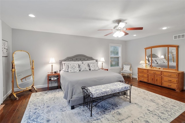 bedroom with dark wood-style flooring, visible vents, baseboards, and recessed lighting