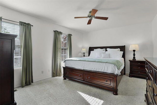 bedroom featuring baseboards, a ceiling fan, and light carpet