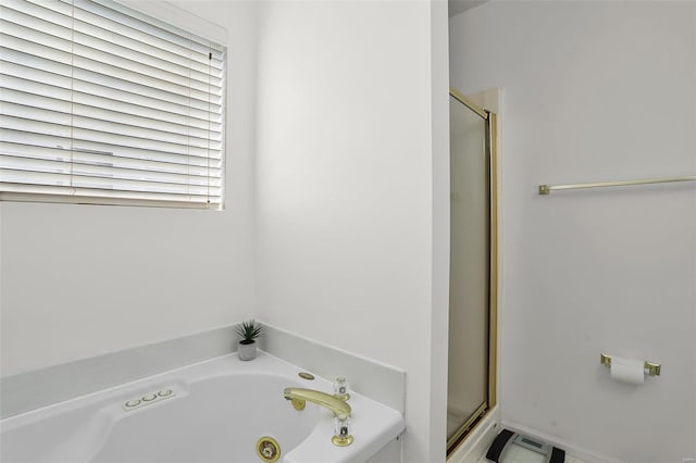 bathroom featuring a whirlpool tub and a stall shower