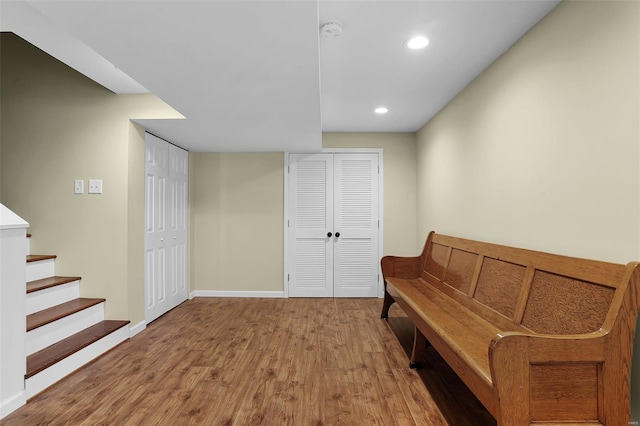 living area with stairway, baseboards, recessed lighting, and wood finished floors