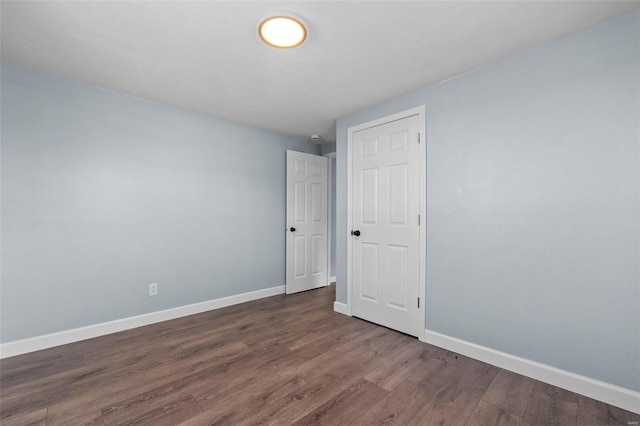 empty room with wood finished floors and baseboards