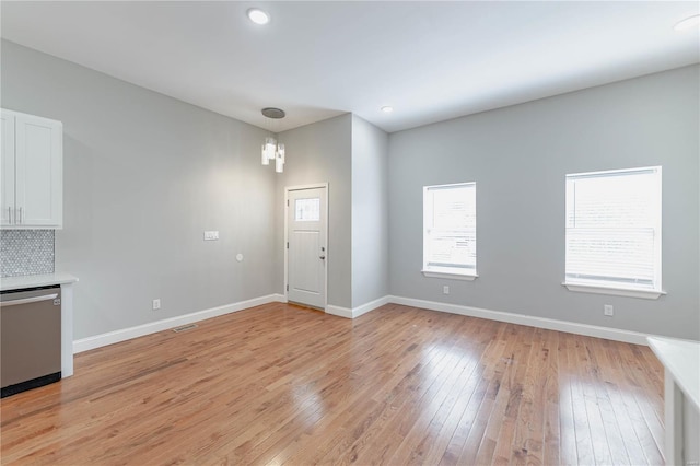entryway featuring baseboards, recessed lighting, light wood-style flooring, and visible vents