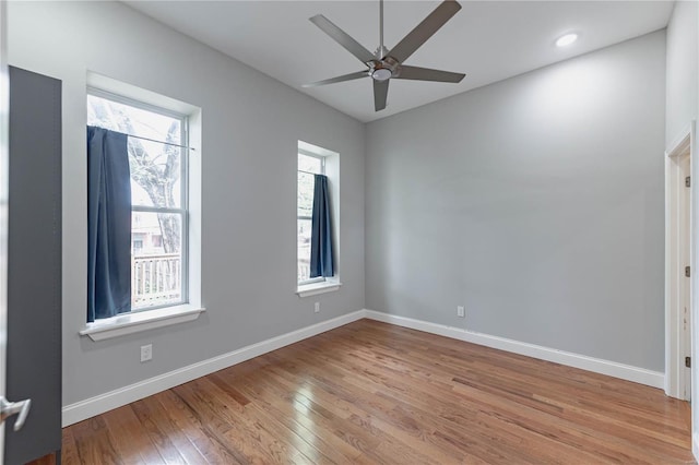 unfurnished room featuring baseboards, ceiling fan, and light wood-type flooring