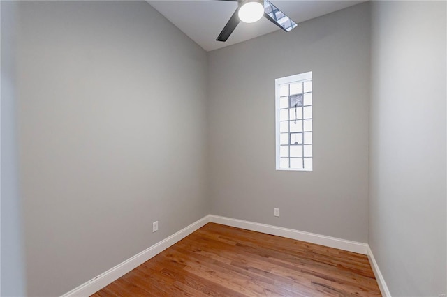 spare room with light wood-style floors, baseboards, and a ceiling fan