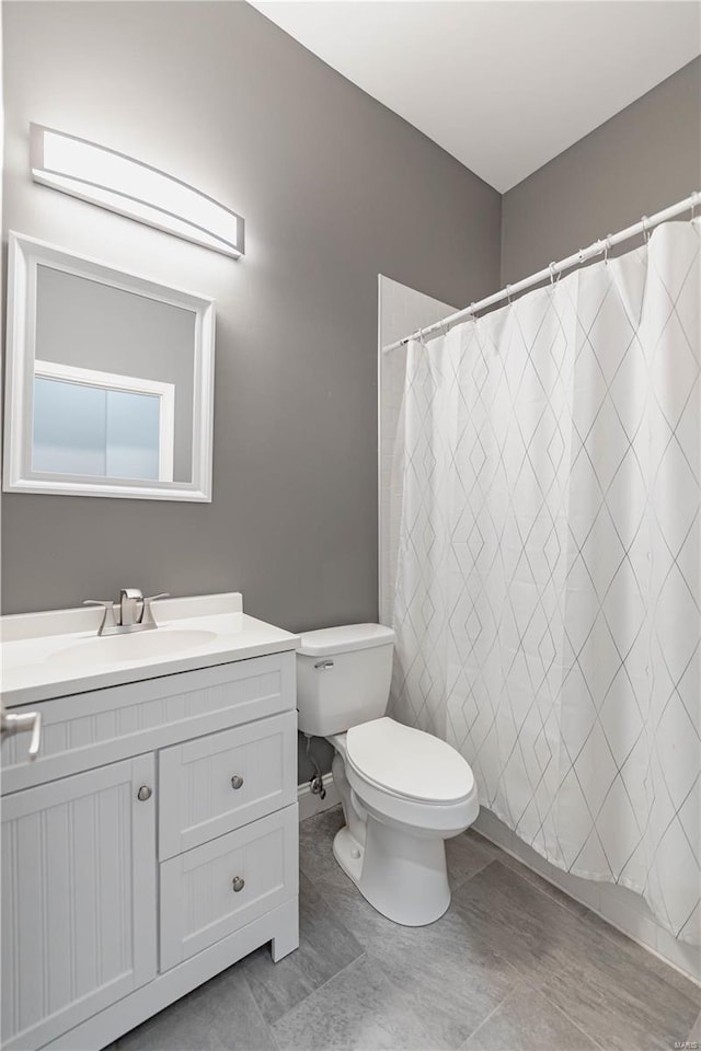 full bathroom with vanity and toilet