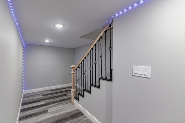 staircase with baseboards, recessed lighting, and wood finished floors