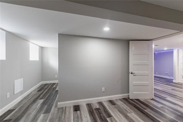 below grade area with recessed lighting, baseboards, and dark wood-style flooring