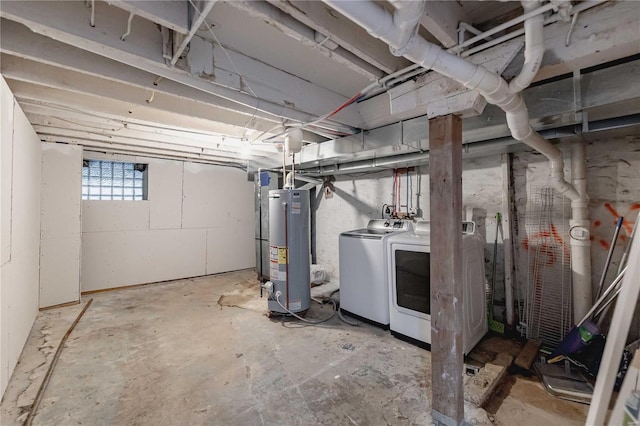 basement featuring water heater and washing machine and clothes dryer