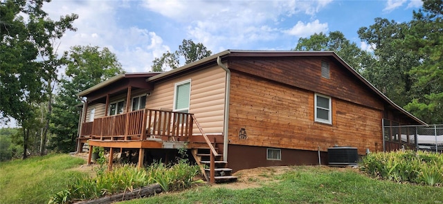 view of property exterior featuring central AC and stairway