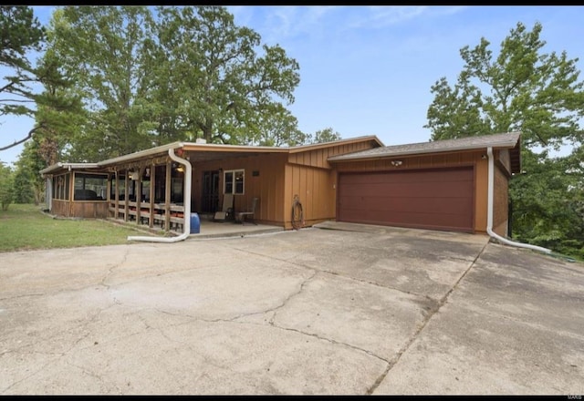 view of front of home with a garage, driveway, and board and batten siding