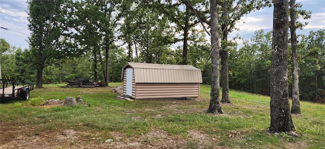 view of yard with a storage shed and an outbuilding