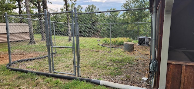 view of yard with cooling unit, fence, and a gate