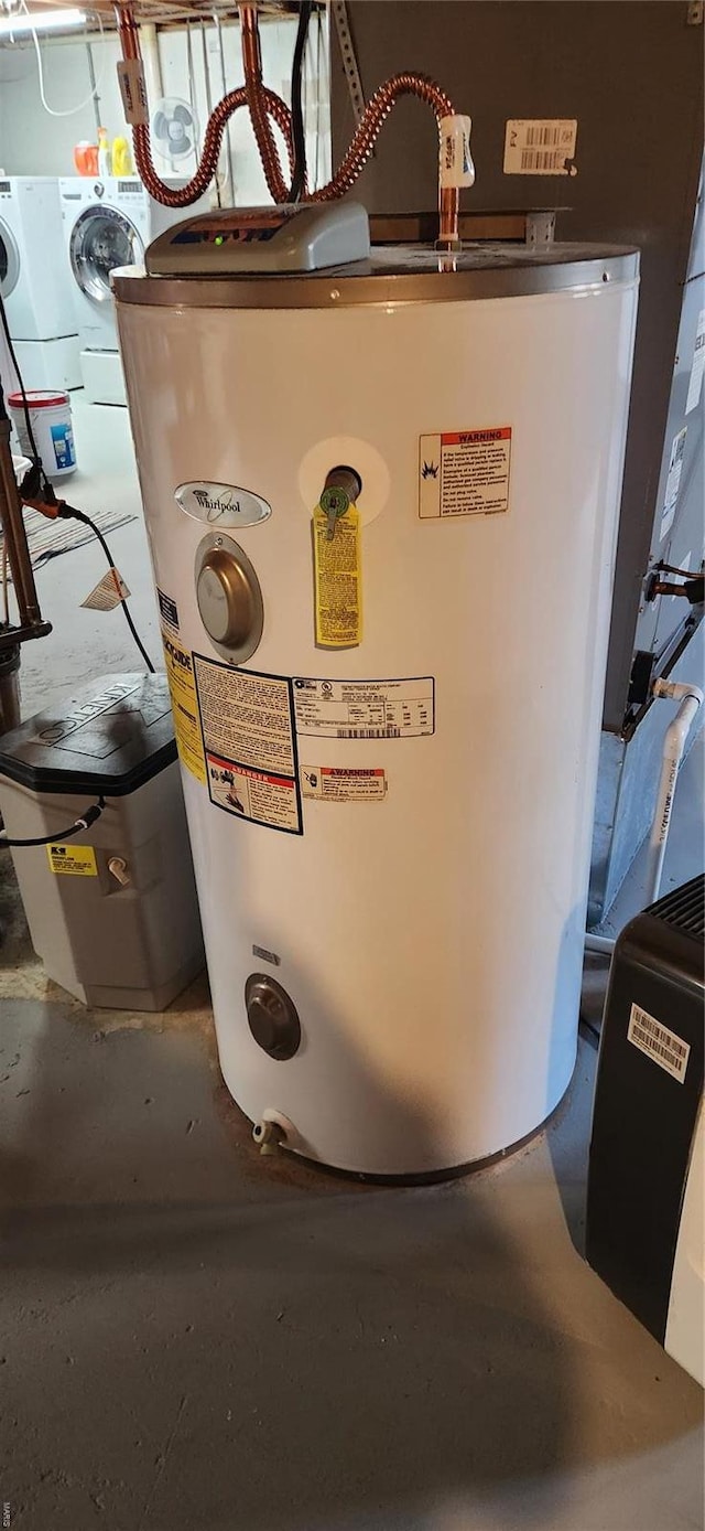 utility room featuring water heater and washer / clothes dryer