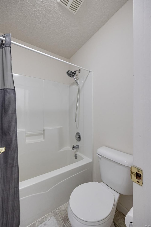 full bath with visible vents, tile patterned flooring, shower / bath combo with shower curtain, toilet, and a textured ceiling