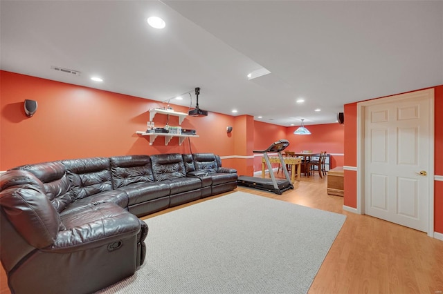 living area with visible vents, baseboards, bar area, recessed lighting, and light wood-style flooring