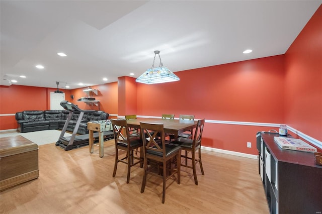 dining space with baseboards, recessed lighting, and light wood finished floors