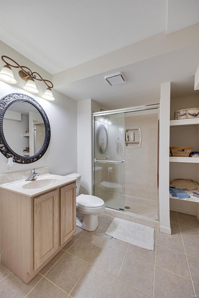 full bathroom with tile patterned flooring, vanity, toilet, and a shower stall