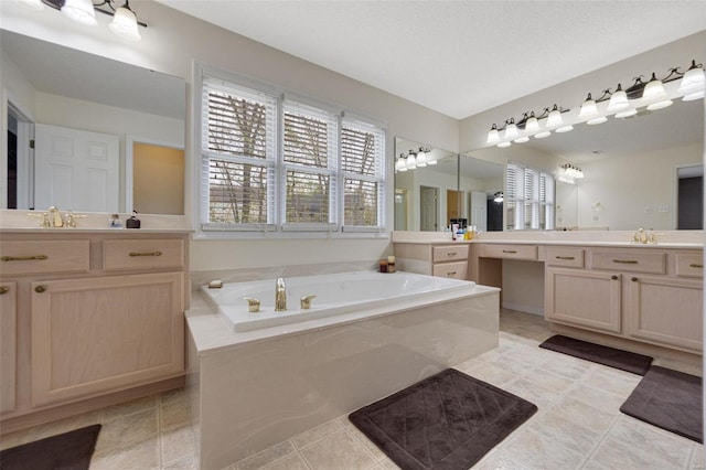 bathroom featuring tile patterned flooring, two vanities, a sink, and a bath