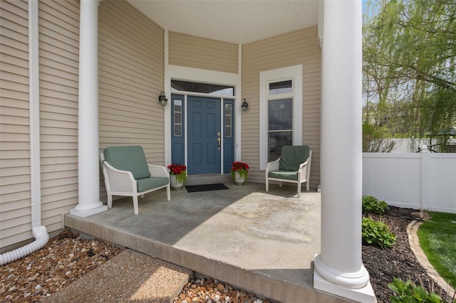 view of patio / terrace featuring a porch and fence