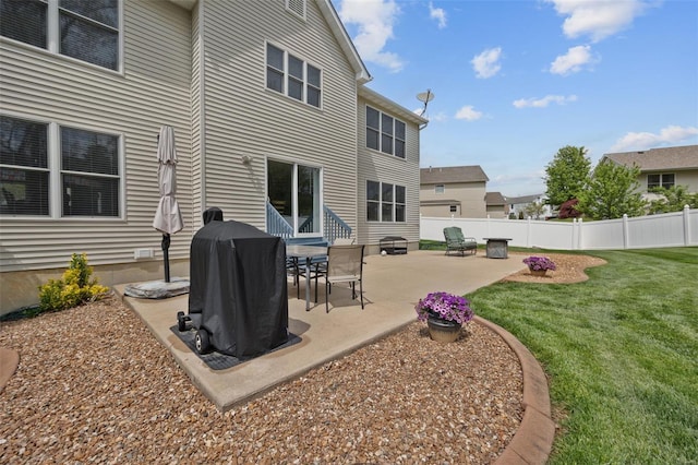 rear view of house featuring a lawn, a patio area, fence, and entry steps