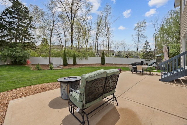 view of patio featuring a fenced backyard and an outdoor fire pit