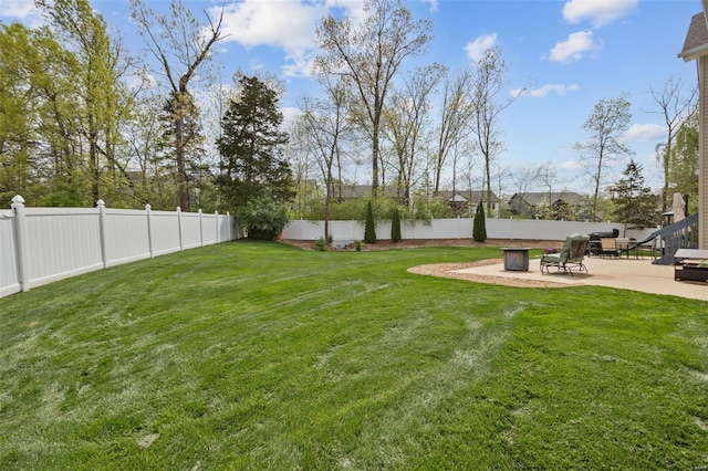 view of yard with a fenced backyard and a patio