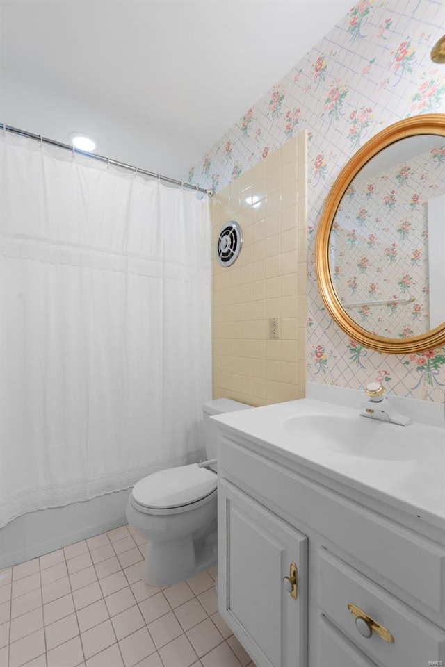 full bathroom with vanity, toilet, tile patterned floors, shower / bathtub combination with curtain, and wallpapered walls
