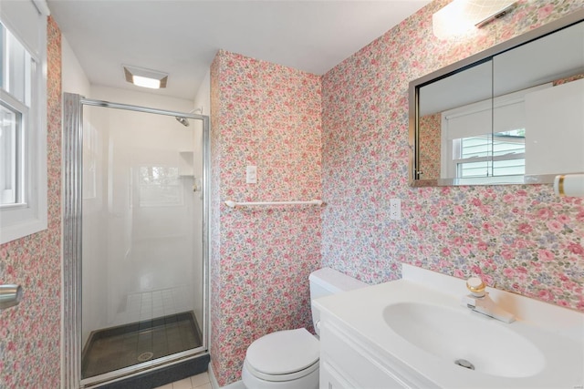 bathroom with vanity, wallpapered walls, a shower stall, and toilet