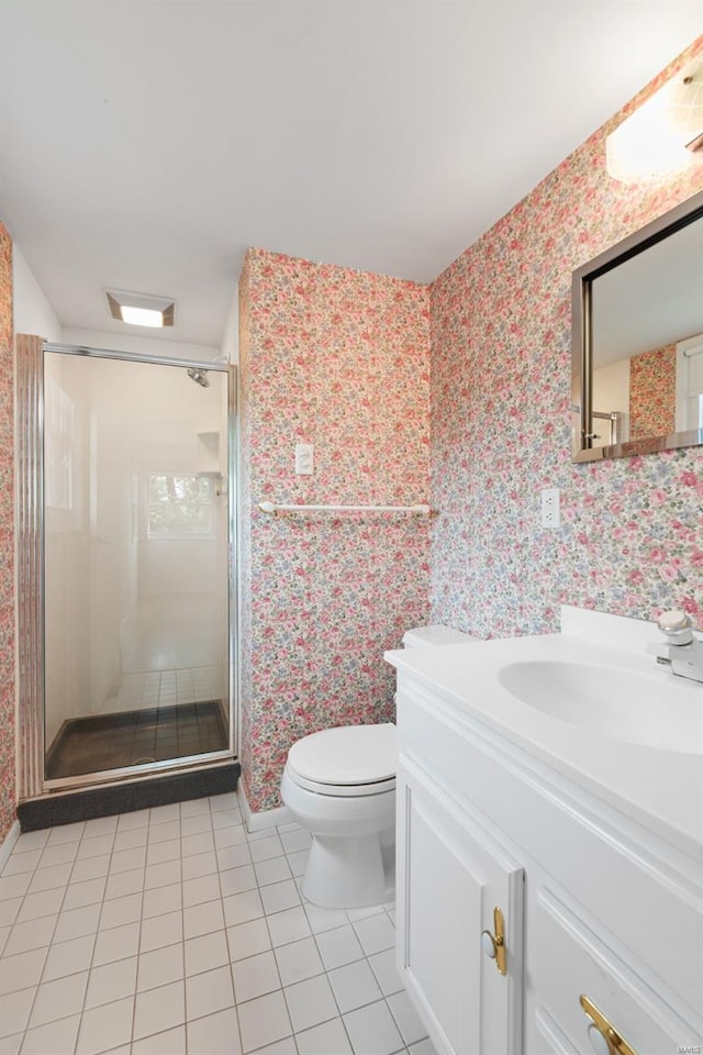 bathroom with tile patterned flooring, vanity, toilet, wallpapered walls, and baseboards