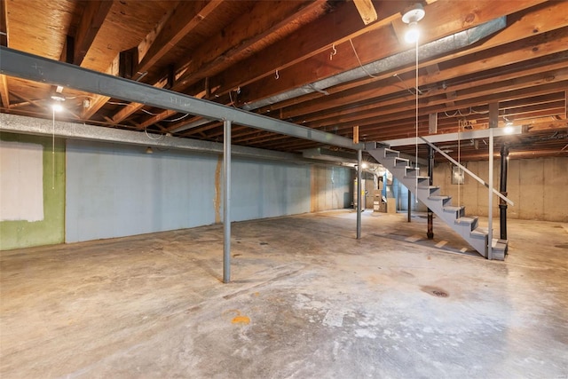 unfinished basement featuring stairway