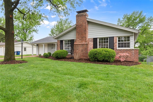 view of front of home with a garage, a front lawn, fence, a chimney, and brick siding