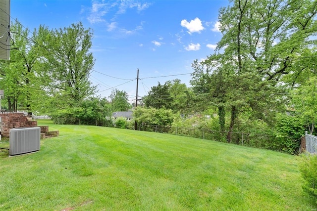 view of yard with fence and cooling unit