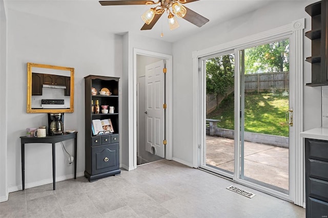 entryway with baseboards, ceiling fan, and visible vents