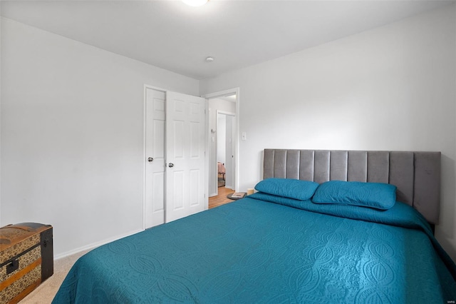 bedroom featuring baseboards and carpet