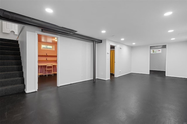 finished basement with stairway, baseboards, and recessed lighting