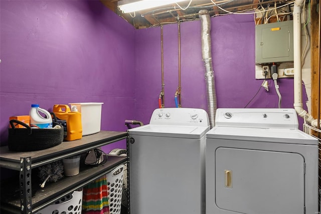 laundry area featuring laundry area, electric panel, and separate washer and dryer
