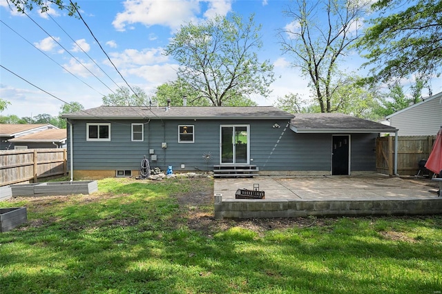 rear view of property with a lawn, fence, a garden, and a patio area