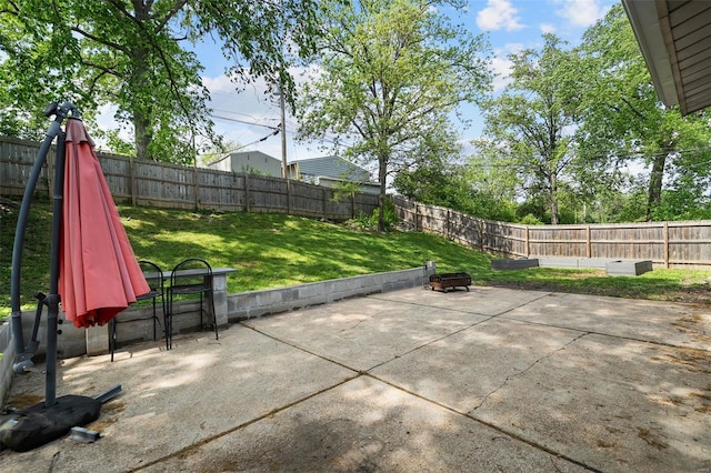 view of patio featuring a fenced backyard and a fire pit