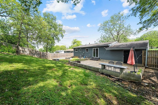 rear view of property with a fenced backyard, a patio, entry steps, and a yard