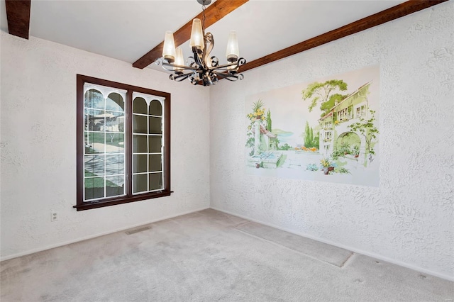 empty room with beamed ceiling, a textured wall, a notable chandelier, and carpet