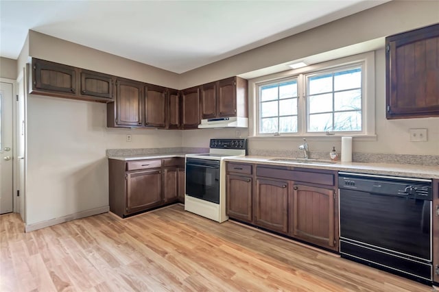 kitchen featuring black dishwasher, a sink, light countertops, under cabinet range hood, and electric range