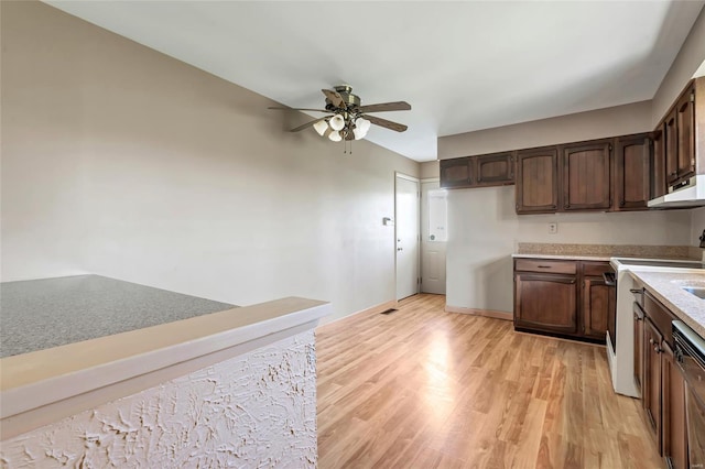 kitchen featuring light countertops, light wood-type flooring, a ceiling fan, under cabinet range hood, and dark brown cabinets