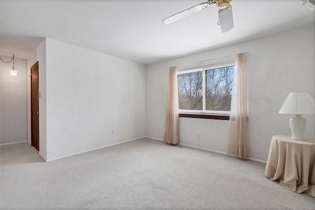 empty room with a textured wall, a ceiling fan, and carpet floors